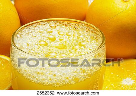 Stock Image - Close-up of glass of orange juice . Fotosearch