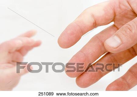 Stock Photo - Close-up of hands of man and baby . Fotosearch