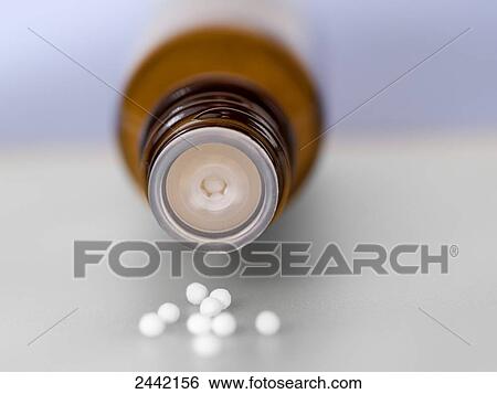 Close-up of homeopathic pills spilling from bottle View Large Photo Image Stock Photograph - Close-up of homeopathic pills spilling from bottle . Fotosearch