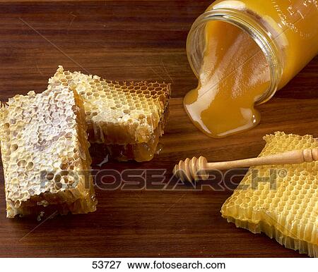 Stock Photo - Close-up of honey and jar . Fotosearch