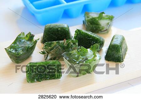 Close-up of ice cubes with herbs on cutting board View Large Photo Image Stock Image - Close-up of ice cubes with herbs on cutting board . Fotosearch