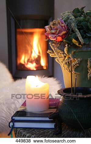 Stock Photo - Close-up of lit candle on book . Fotosearch