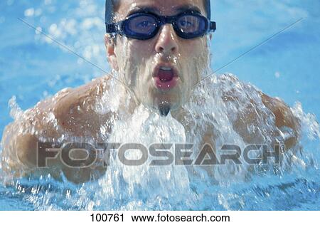 Stock Image - Close-up of male swimmer swimming in swimming pool . Fotosearch