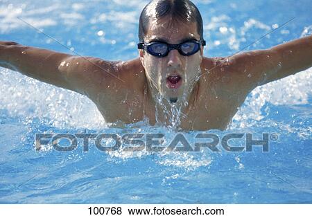 Close-up of male swimmer swimming in swimming pool View Large Photo Image Stock Photo - Close-up of male swimmer swimming in swimming pool . Fotosearch