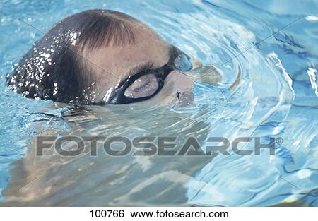 Close-up of male swimmer swimming in swimming pool View Large Photo Image Stock Photograph - Close-up of male swimmer swimming in swimming pool . Fotosearch