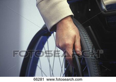 Stock Image - Close-up of man on wheelchair . Fotosearch