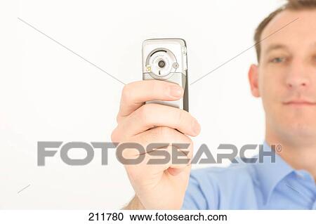 Close-up of mid adult man taking photograph with mobile phone View Large Photo Image Stock Image - Close-up of mid adult man taking photograph with mobile phone . Fotosearch