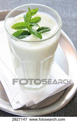 Stock Photo - Close-up of mint leaves in glass of milk . Fotosearch