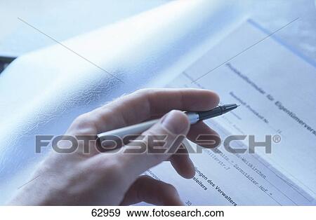Close-up of person's hand holding pen View Large Photo Image Stock Photo - Close-up of person's hand holding pen . Fotosearch