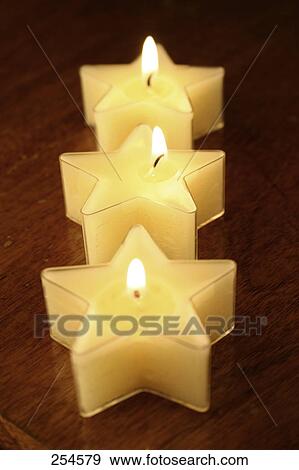 Close-up of star shape lit candles View Large Photo Image Stock Photo - Close-up of star shape lit candles . Fotosearch