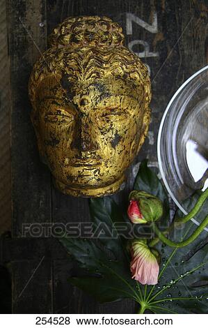 Close-up of statue of Buddha and flower buds View Large Photo Image Stock Photo - Close-up of statue of Buddha and flower buds . Fotosearch