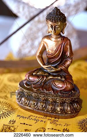 Stock Image - Close-up of statue of Buddha . Fotosearch