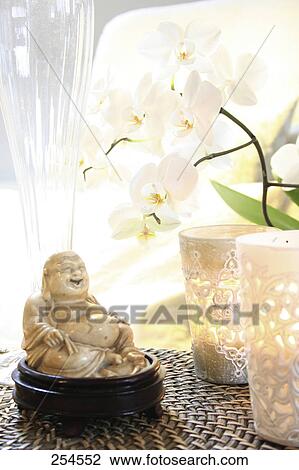 Close-up of statue of laughing Buddha and lamps View Large Photo Image Stock Image - Close-up of statue of laughing Buddha and lamps . Fotosearch