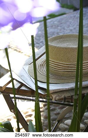 Stock Photo - Close-up of straw hat on table . Fotosearch
