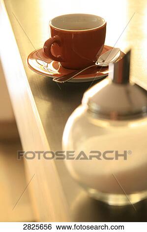 Close-up of sugar sprinkler with coffee cup on saucer View Large Photo Image Stock Photograph - Close-up of sugar sprinkler with coffee cup on saucer . Fotosearch