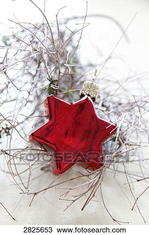 Stock Image - Close-up of twigs and star on white background . Fotosearch
