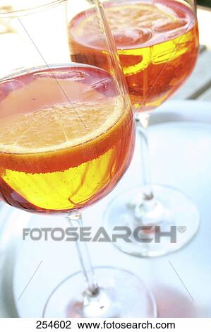 Close-up of two glasses of cocktails and slices of orange View Large Photo Image Stock Image - Close-up of two glasses of cocktails and slices of orange . Fotosearch