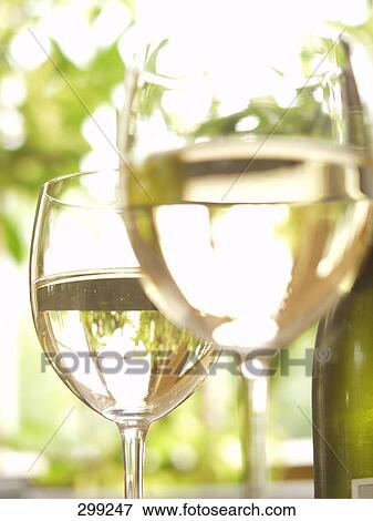 Stock Photo - Close-up of two glasses of white wine . Fotosearch