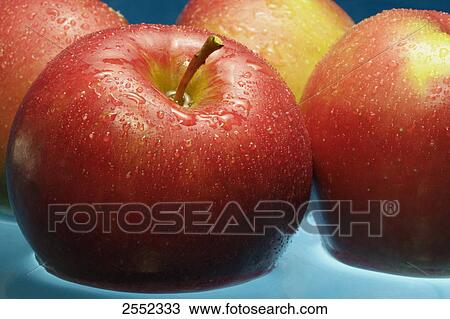 Stock Image - Close-up of water droplets on apples . Fotosearch