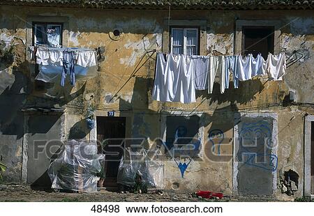 Clothes drying in front of old house, Mouraria, Lisbon, Portugal View Large Photo Image Stock Photo - Clothes drying in front of old house, Mouraria, Lisbon, Portugal . Fotosearch