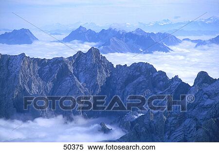 Stock Photography - Clouds around mountains, Wetterstein Mountains, Bavaria, Germany . Fotosearch