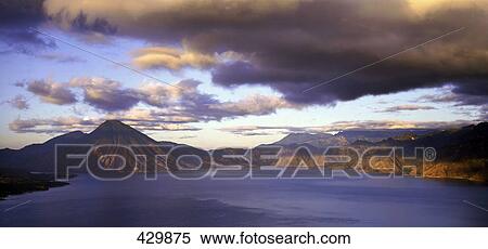Stock Photography - Clouds over mountain range, Lake Atitlan, Guatemala . Fotosearch