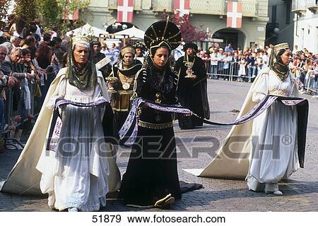 Stock Photo - Crowd looking at people in costumes during festival, Palio, Asti, Piedmont, Italy . Fotosearch