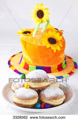 Doughnuts on a plate in front of a colourful hat, high angle view View Large Photo Image Stock Image - Doughnuts on a plate in front of a colourful hat, high angle view . Fotosearch