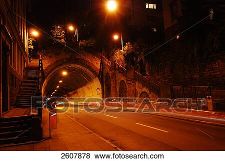 Empty tunnel lit up at night View Large Photo Image Stock Photo - Empty tunnel lit up at night . Fotosearch