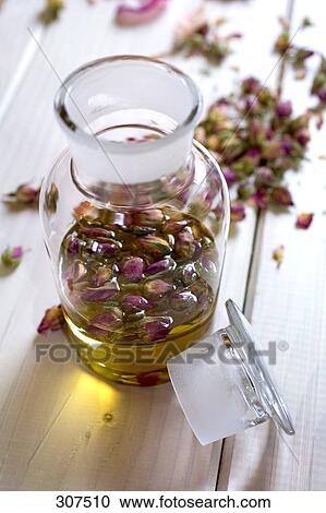 Essence of roses on table View Large Photo Image Stock Image - Essence of roses on table . Fotosearch
