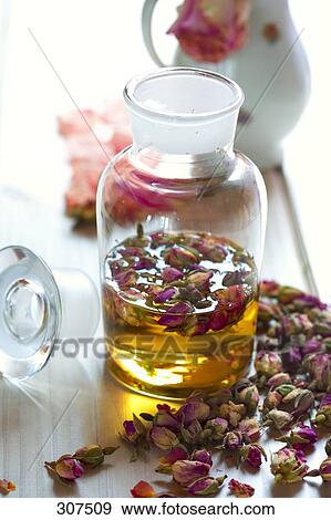 Essence of roses on table View Large Photo Image Stock Photo - Essence of roses on table . Fotosearch