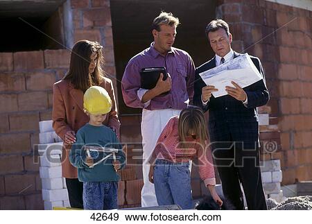 Family planning with architect View Large Photo Image Stock Photo - Family planning with architect . Fotosearch