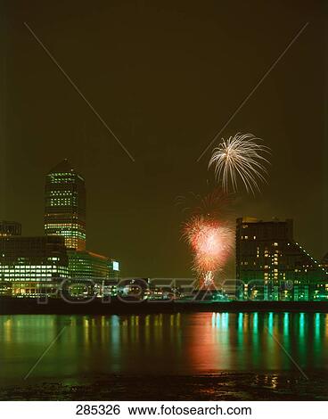 Fireworks over city, Canary Wharf, Thames River, London, England View Large Photo Image Stock Photograph - Fireworks over city, Canary Wharf, Thames River, London, England . Fotosearch