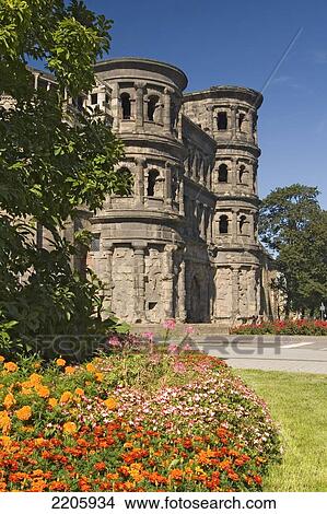 Picture - Flowers blooming in front of old roman building, Porta Nigra, Trier, Rheinland-Pfaltz, Germany . Fotosearch