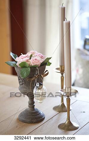 Flowers in a drinking vessel beside two candleholders View Large Photo Image Stock Image - Flowers in a drinking vessel beside two candleholders . Fotosearch
