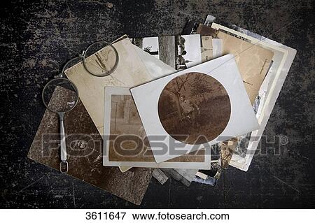 Stock Photo - Glasses and old photos . Fotosearch