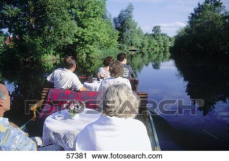Stock Image - Group of tourists traveling in a boat, Lubbenau, Brandenburg, Germany . Fotosearch