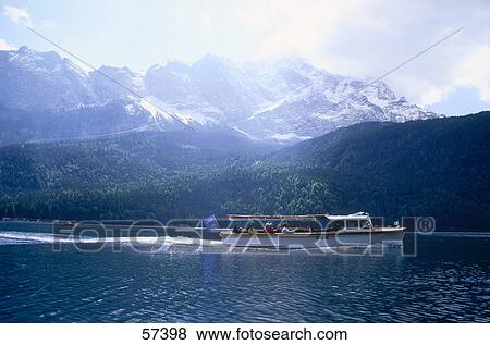 Stock Photo - Group of tourists traveling in a tour boat, Wetterstein Mountains, Zugspitze, Upper Bavaria, Germany . Fotosearch