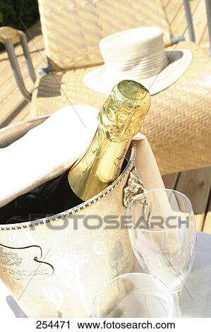 Stock Image - High angle view of Champagne bottle in ice bucket . Fotosearch