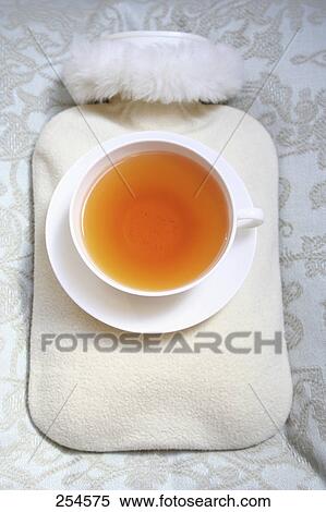 High angle view of cup of black tea and hot water bottle View Large Photo Image Stock Photography - High angle view of cup of black tea and hot water bottle . Fotosearch