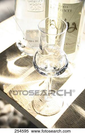 Stock Photography - High angle view of glass and bottle of white wine . Fotosearch