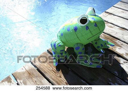 High angle view of inflatable frog at edge of swimming pool View Large Photo Image Stock Photo - High angle view of inflatable frog at edge of swimming pool . Fotosearch