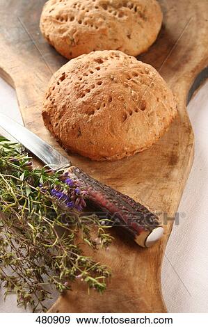 Stock Photo - High angle view of knife and loaf of breads on cutting board . Fotosearch