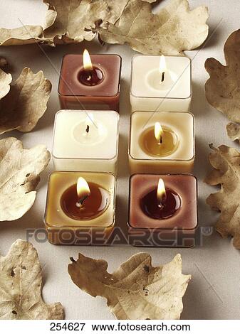 High angle view of lit candles and autumn leaves View Large Photo Image Stock Photo - High angle view of lit candles and autumn leaves . Fotosearch