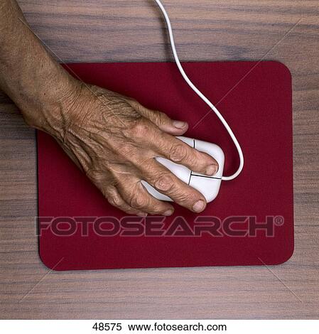 Stock Photography - High angle view of woman using computer mouse . Fotosearch