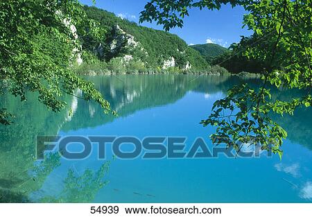 Stock Photo - Hills and blue sky reflected in the lake water, Krka National Park, Dalmatia, Croatia . Fotosearch