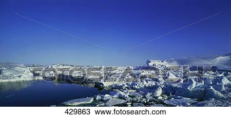 Stock Image - Icebergs floating on water in fjord . Fotosearch