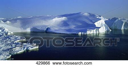 Stock Photograph - Icebergs floating on water in fjord . Fotosearch