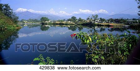 Stock Photo - Lake in front of mountain range, Annapurna Range, Himalayas, Lake Phewa, Pokhara, Nepal . Fotosearch