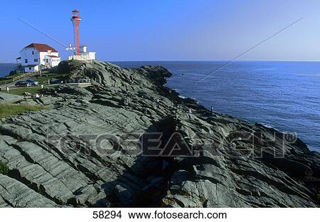 Picture - Lighthouse on a cliff on a coast, Nova Scotia, Canada . Fotosearch
